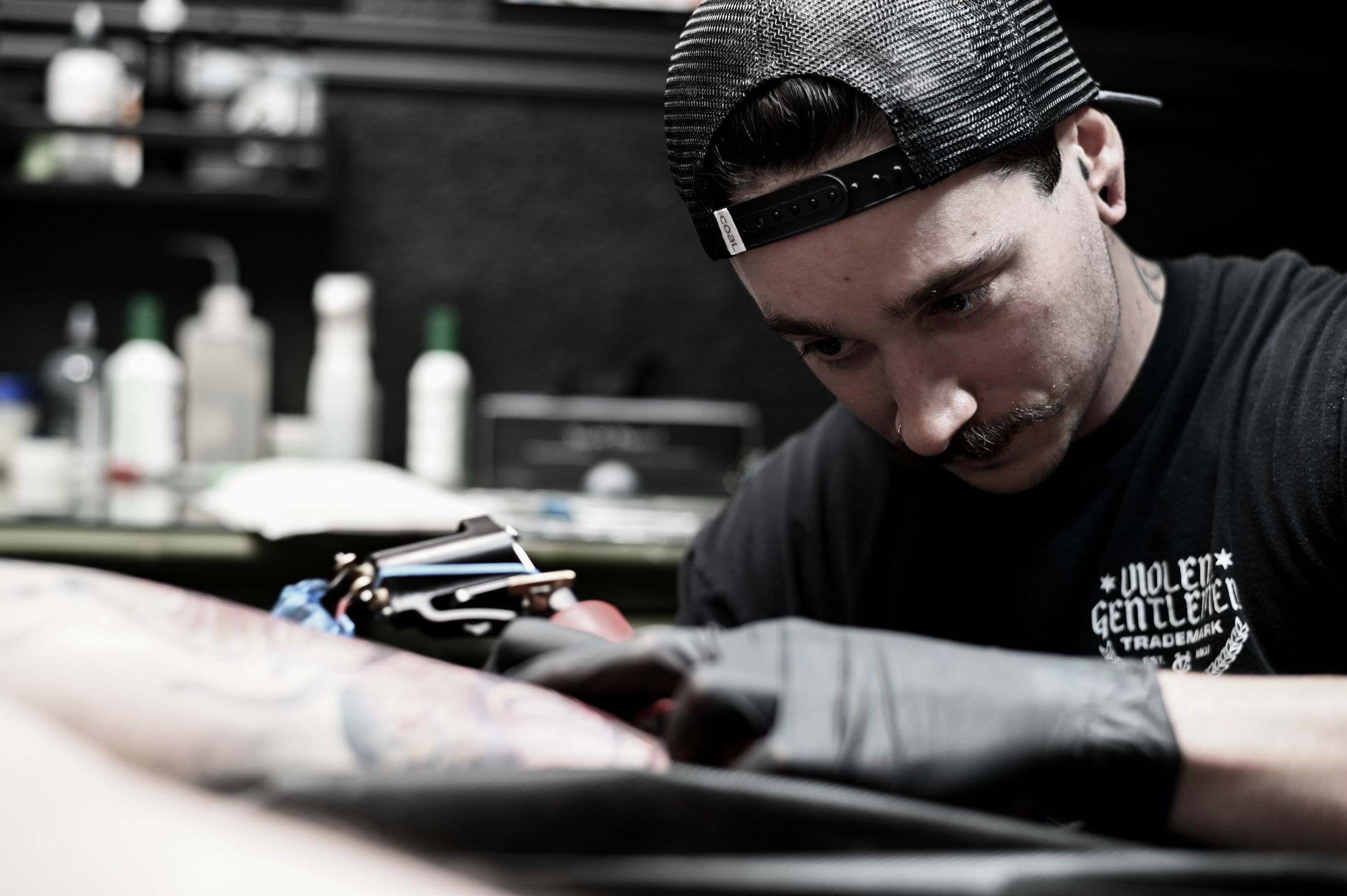 Austin Hermans working on a tattoo