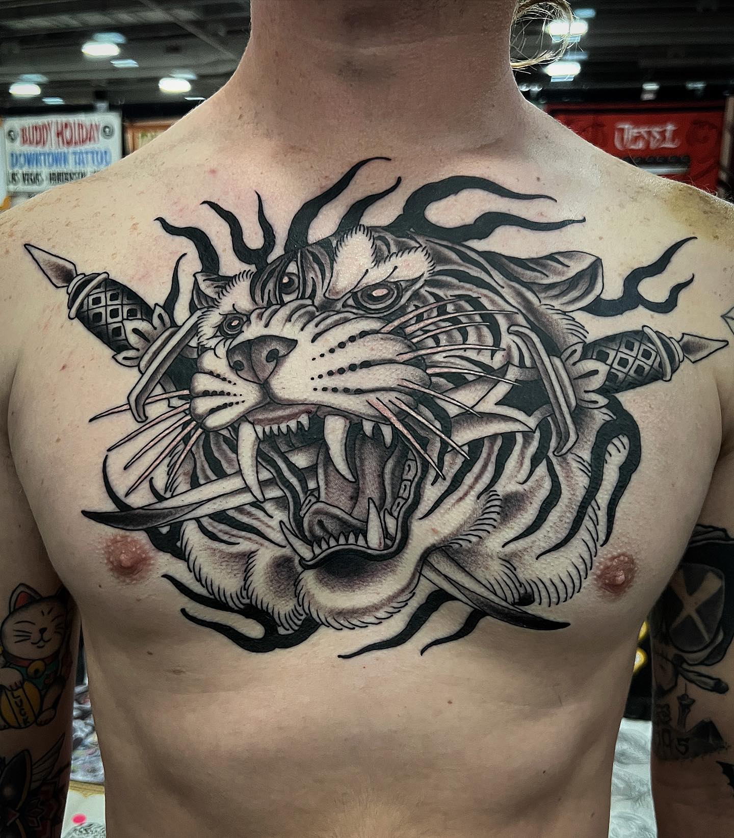 A bold tiger and swords chest tattoo by Austin Hermans