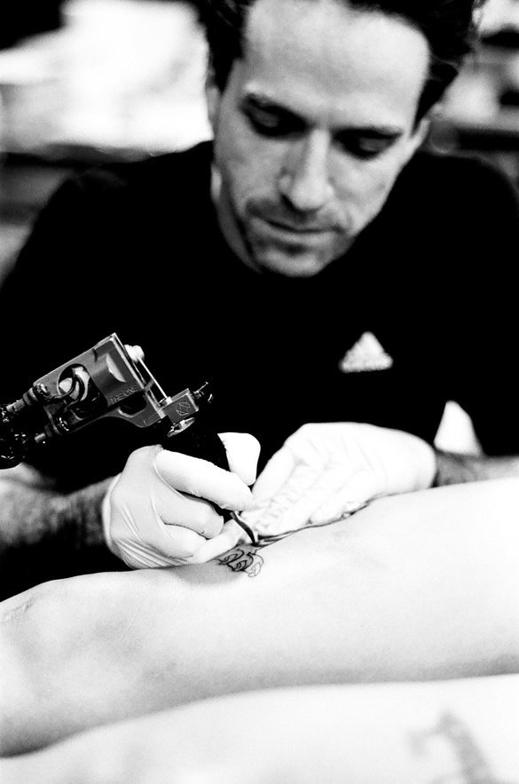 Cam Kelley concentrating on his tattoo work