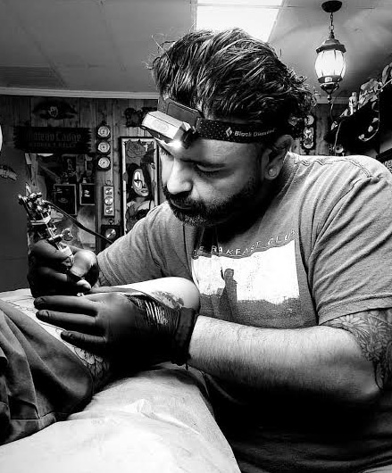 Josh Echevarria, also known as Josh Etch, tattooing